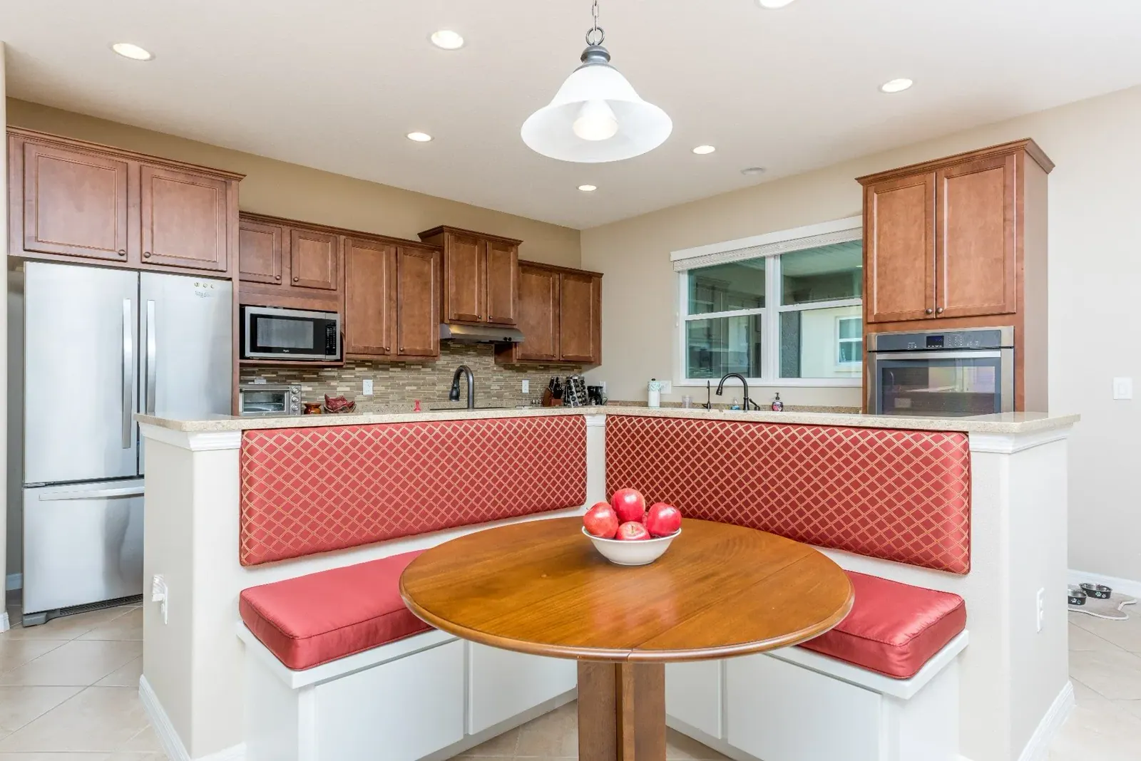 Kitchen Banquette, An L-shaped breakfast nook with custom seat cushions and diamond-patterned backrest panels, built for daily use. By Custom Fabric Creations, St. Petersburg, FL.