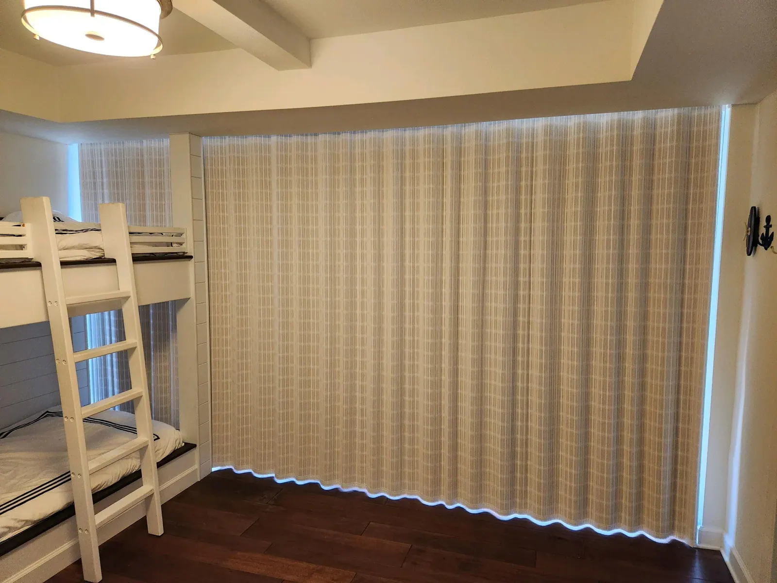 Ripple-Fold Sheers, Wall-to-wall ripple-fold sheers in a bedroom, mounted at the ceiling so the fabric hangs in even S-curves. By Custom Fabric Creations, St. Petersburg, FL.